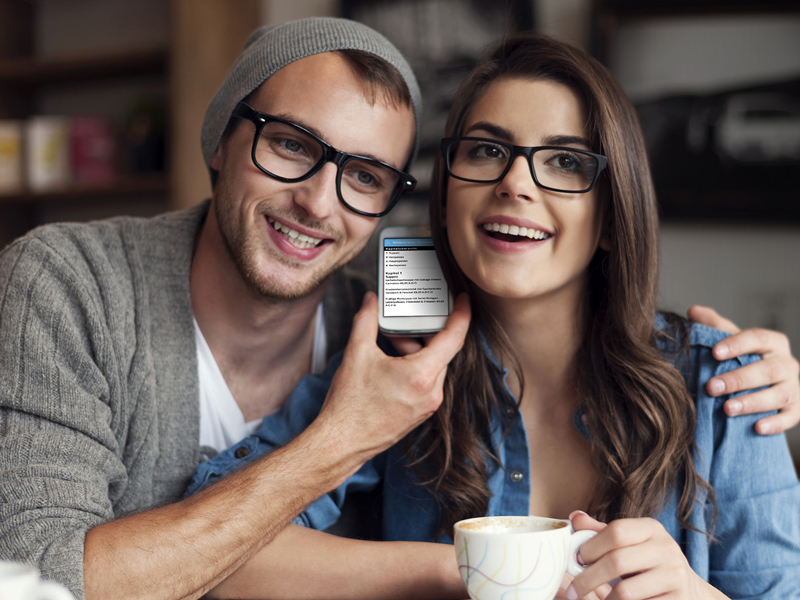 Young smiling couple., both wearing glasses, listen to a menu via their smartphone